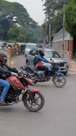 Mixed traffic flows past St. Mary's Cathedral in Dhaka