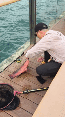 Angler lands red fish on Hong Kong pier