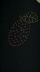 Drone light show displays pineapple, text in Sofia evening sky