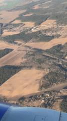 Aerial view captures rural Belarus countryside from airplane window