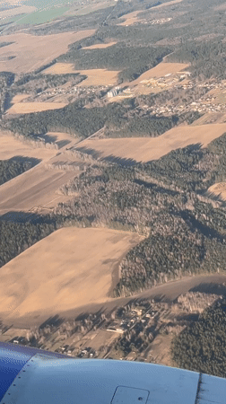 Aerial view captures rural Belarus countryside from airplane window