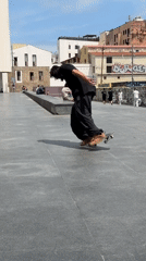 Skateboarders perform tricks at Barcelona plaza during afternoon session