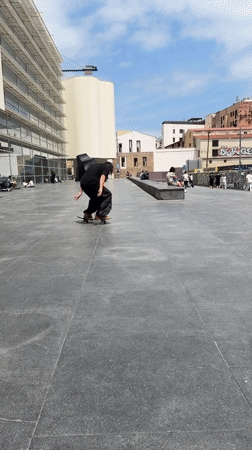 Skateboarders perform tricks at Barcelona plaza during afternoon session