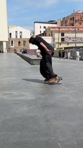 Skateboarders perform tricks at Barcelona plaza during afternoon session