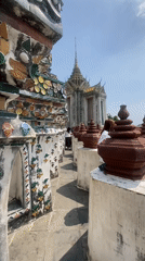 Tourist documents ornate walkway at Bangkok's Temple of Dawn
