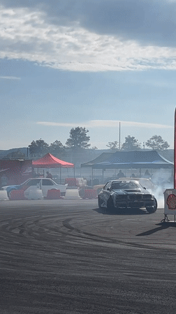 Drift competition at Dospey track, multiple cars and sponsors on show