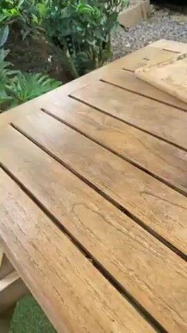 The video shows a wooden table with a variety of items. There's a vape, a can, a glass of liquid with floating objects, a small box with a cupcake and brownies, a plate of green noodles and crackers, and a plate of chocolate sticks.