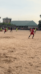 Community football match played on sandy field in Umuode