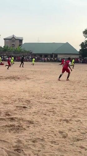 Community football match played on sandy field in Umuode