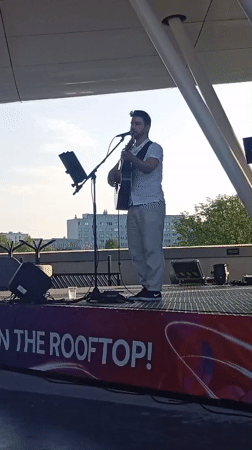 Acoustic set on a rooftop stage in Wrocław