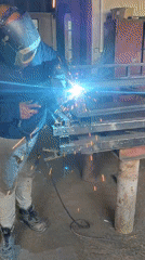 Welder works on metal structure in Burgas workshop