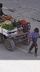 Morning street activity: hauling goods through a disrupted urban area