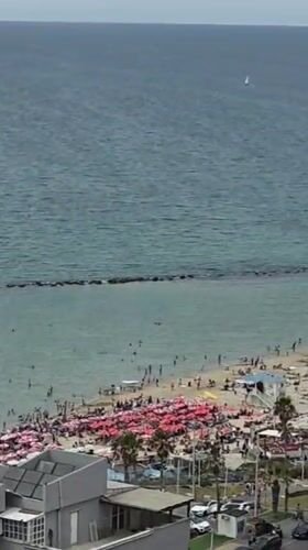 Aerial view captures crowded beach scene in Bat Yam