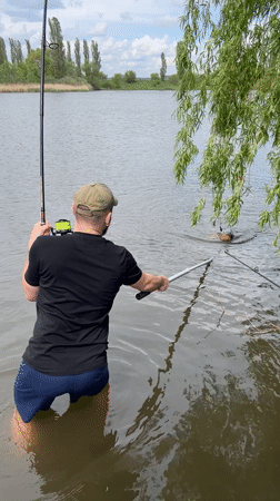 Angler catches large carp in Romanove Selo, Ukraine