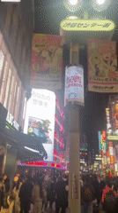 Night scene captured on crowded, illuminated Shibuya street