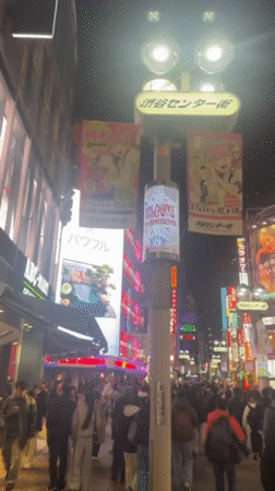 Night scene captured on crowded, illuminated Shibuya street
