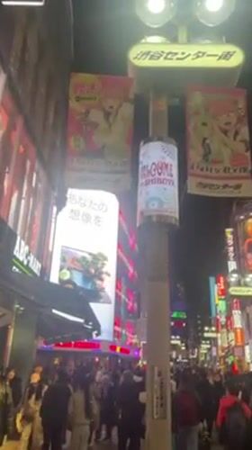 Night scene captured on crowded, illuminated Shibuya street
