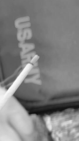 The video shows a close-up of incense sticks. A hand places more incense sticks next to the stick already shown. It then quickly pans over various surfaces and then blurs out the background.