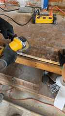 Woodworker sands wooden strip with angle grinder in Mexico