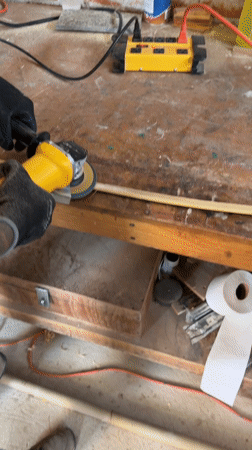 Woodworker sands wooden strip with angle grinder in Mexico