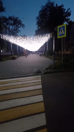 Evening stroll along a lit pedestrian walkway in Belogorsk
