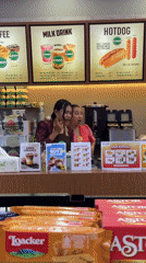 Two women staff store counter in Ubud District