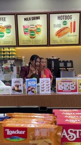 Two women staff store counter in Ubud District