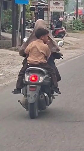 Motorcycle traffic on a busy Lhokseumawe street