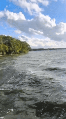 Choppy lake day at a Belarusian beach with red flags flying