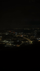 Aerial nighttime footage captures illuminated Huangpu District from aircraft
