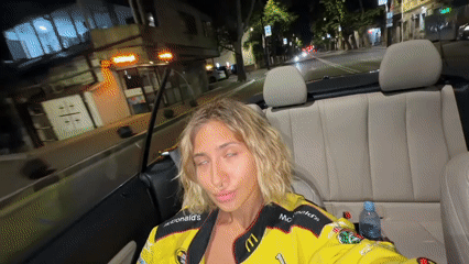 Late-night drive through Tbilisi with fast food drinks in hand