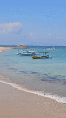 Morning beach activities in Denpasar feature kitesurfing and group gatherings