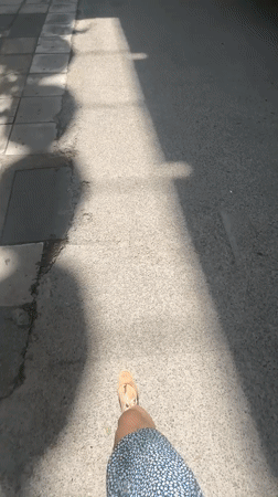 Person records walk past Hotel Kastoria in Thessaloniki
