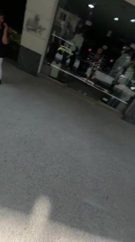 Person records walk past Hotel Kastoria in Thessaloniki