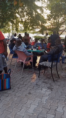 Men celebrate birthday gathering outdoors in Lokoja, Nigeria