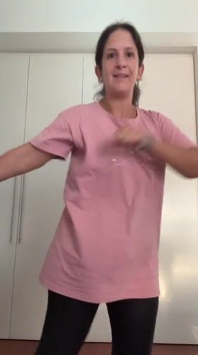 Woman dances indoors in San Isidro, Peru residential setting