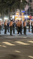 Nighttime street event in Đà Nẵng mixes drill routines, drones, and crowd activity