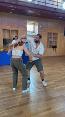 Couple performs swing dancing in Almada hall