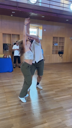 Couple performs swing dancing in Almada hall