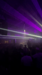 Concert performance observed in Lyon venue with purple lighting