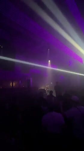 Concert performance observed in Lyon venue with purple lighting