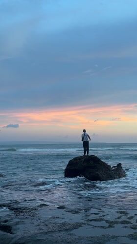 Beach recreation captured at sunset in Mengwi, Indonesia