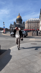 Man makes peace sign while walking in Saint Petersburg