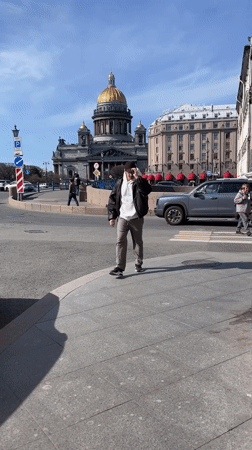 Man makes peace sign while walking in Saint Petersburg