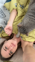 Woman and gray cat share quiet morning moment in Saint Petersburg