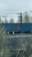 Railway workers inspect train car in rural Russia