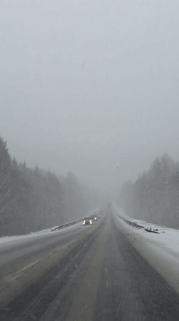 Driver documents snowy highway conditions near Chaykovsky, Russia