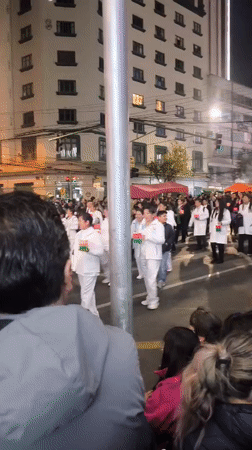 Nighttime street parade rolls through La Paz with lanterns and floats