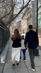 Couple walks with small robot on Moscow sidewalk