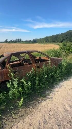 Burnt-out abandoned car documented in Makiv, Ukraine